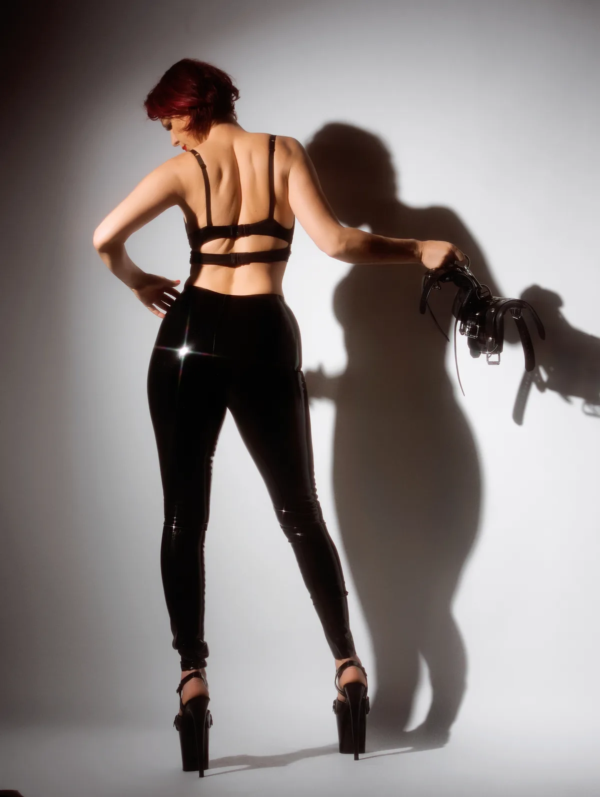 NYC Dominatrix Viktoria Sway in latex, shadow-lit editorial portrait