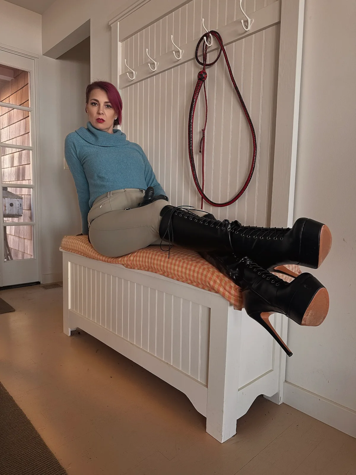 Viktoria Sway reclined in leather — composed authority.