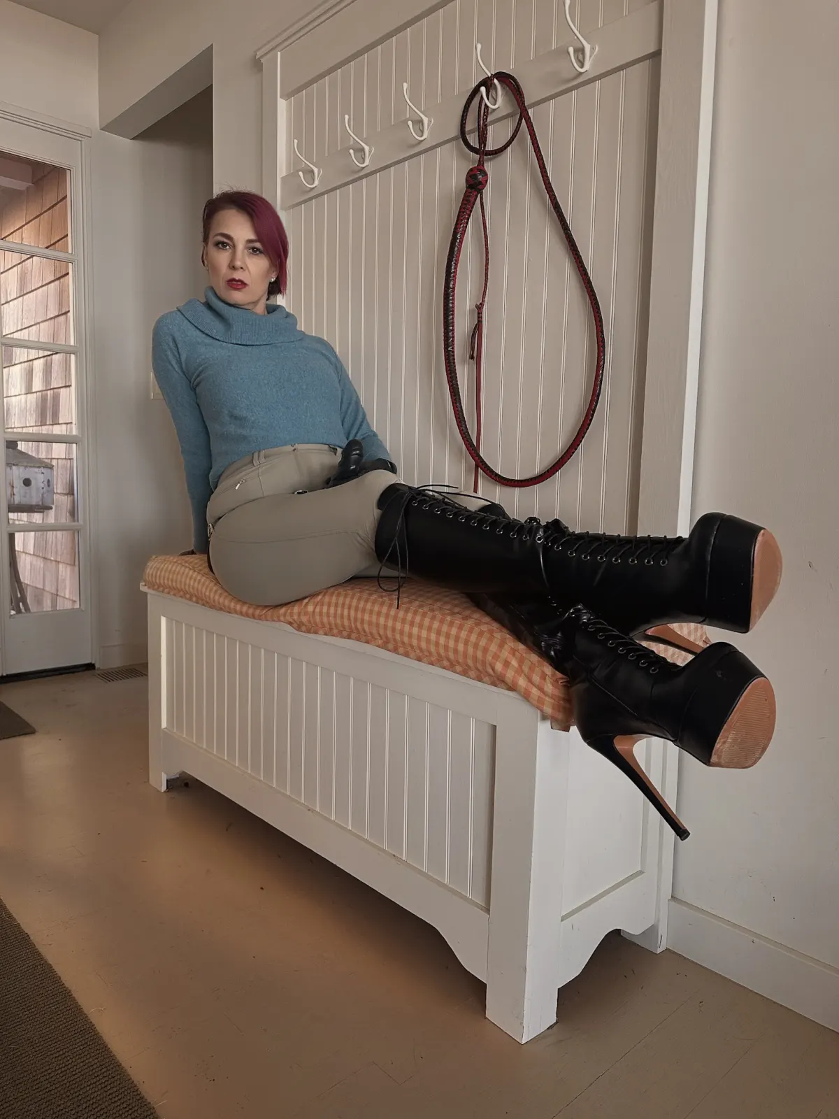 Viktoria Sway reclined in leather — composed authority.